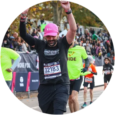Sam mid-race at the NYC Marathon, arms up